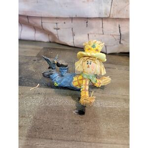 Scarecrow laying down crow hay sunflower fall harvest‎ decor
